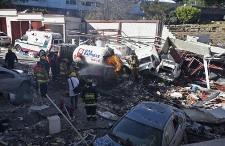 Rescue workers extinguish a fire at a children's hospital after a gas truck exploded, in Cuajimalpa on the outskirts of Mexico City, Thursday, Jan. 29, 2015. The powerful gas tank truck explosion shattered the hospital on the western edge of Mexico's capital, killing at least two, injuring dozens. (AP Photo)